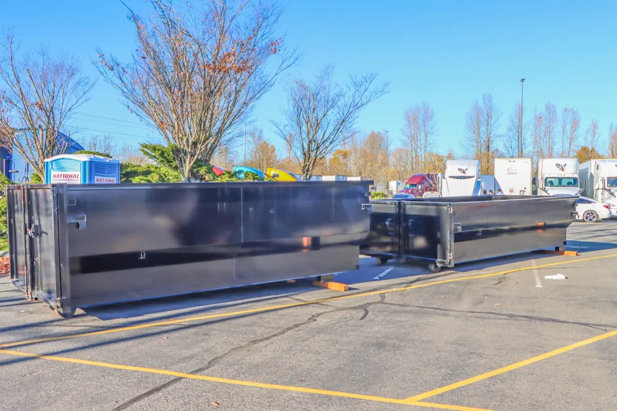 Professional dumpster rental service with roll-off container on residential driveway in Westmoreland